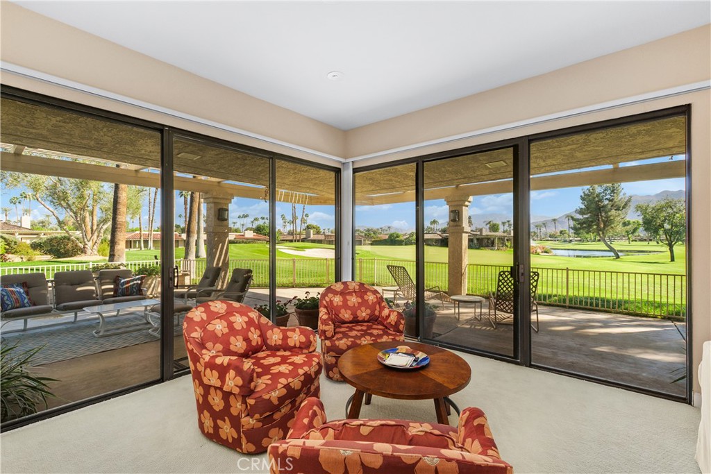 5 Princeton Drive Rancho Mirage, CA 92270 - Photo 8 of 27 a living room with furniture and a floor to ceiling window