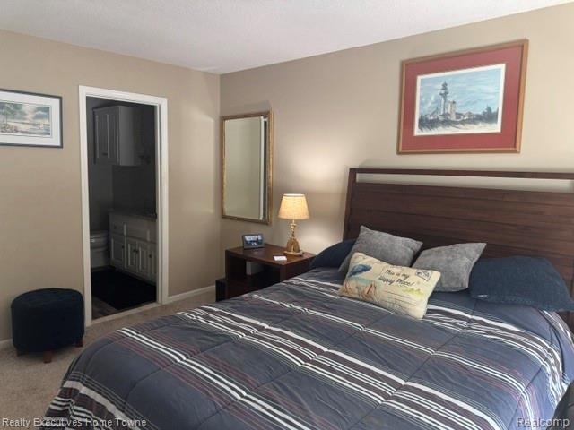 1467 Krafft Road, Unit 8 Port Huron, MI 48060 - Photo 12 of 28 Bedroom featuring a wood-finish headboard and neutral-toned carpeting