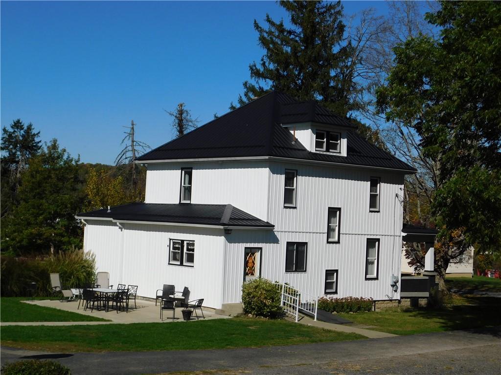a view of a white house with a yard