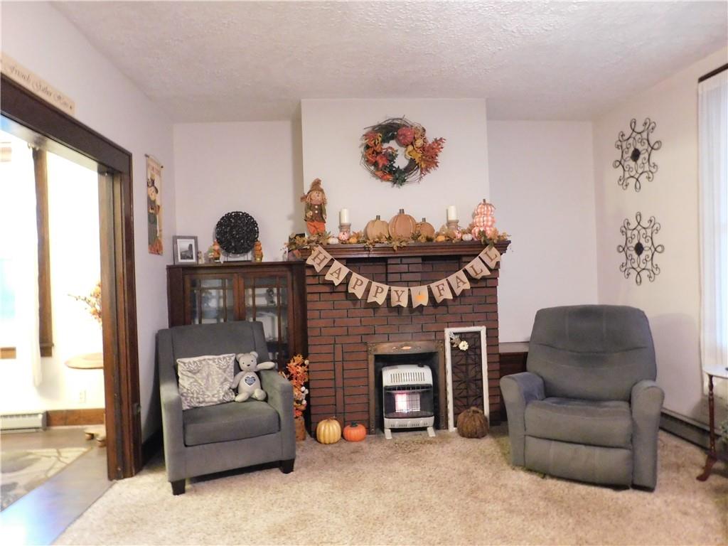 235 Ridge Road Brownsville, PA 15417 - Photo 12 of 42 a living room with furniture a fireplace and a large window