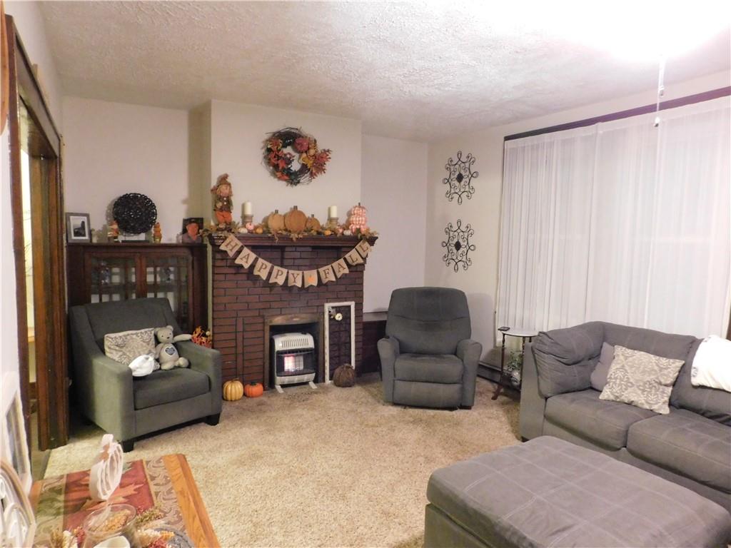 235 Ridge Road Brownsville, PA 15417 - Photo 13 of 42 a living room with furniture and a fireplace
