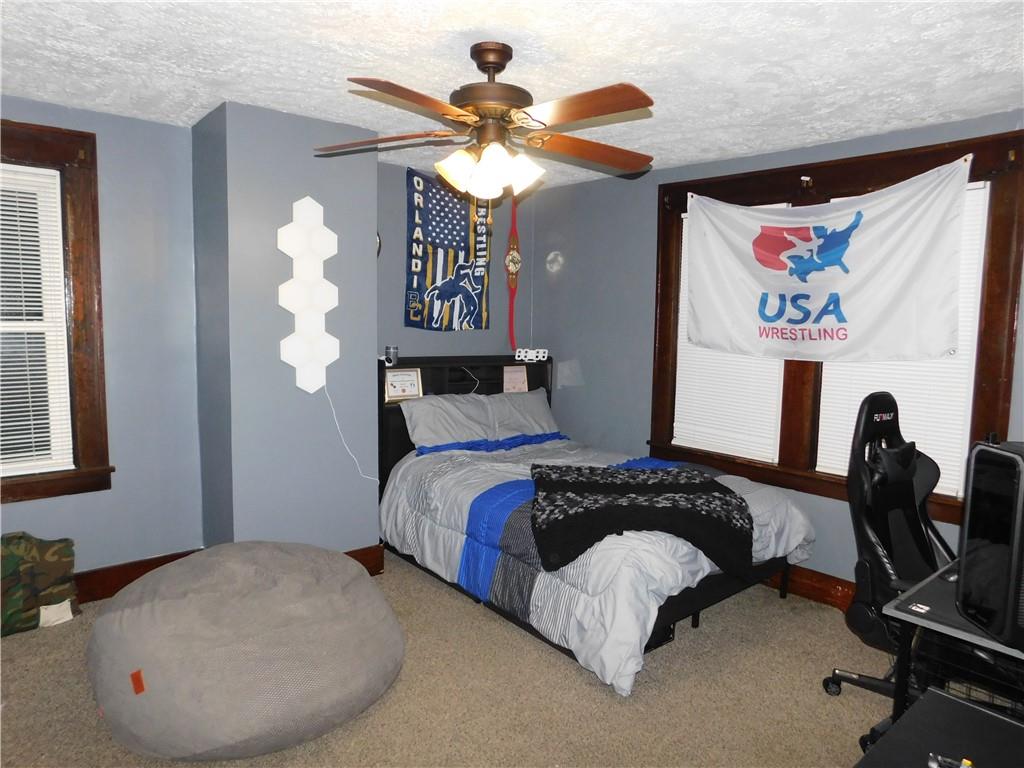 235 Ridge Road Brownsville, PA 15417 - Photo 20 of 42 a bedroom with a bed and a chandelier