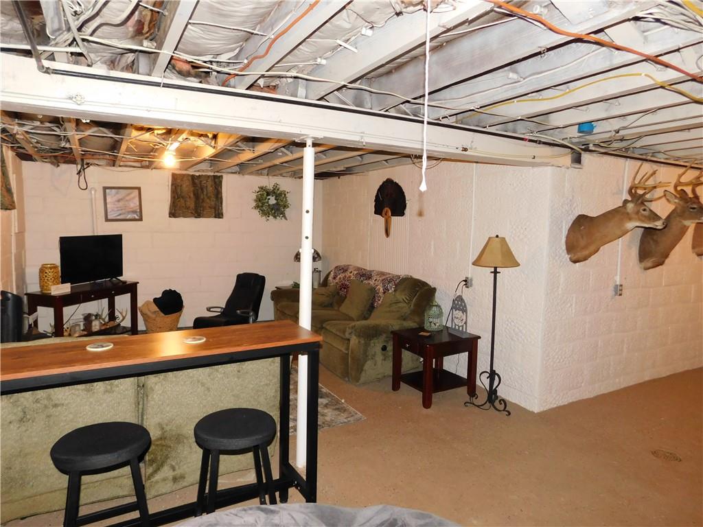 235 Ridge Road Brownsville, PA 15417 - Photo 24 of 42 a dining room with furniture and a flat screen tv