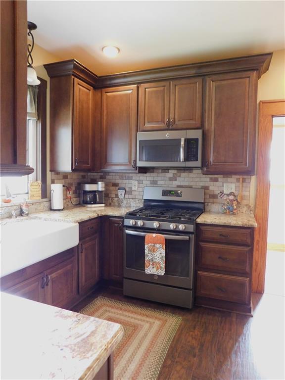 235 Ridge Road Brownsville, PA 15417 - Photo 7 of 42 a kitchen with stainless steel appliances granite countertop a stove a sink and a microwave