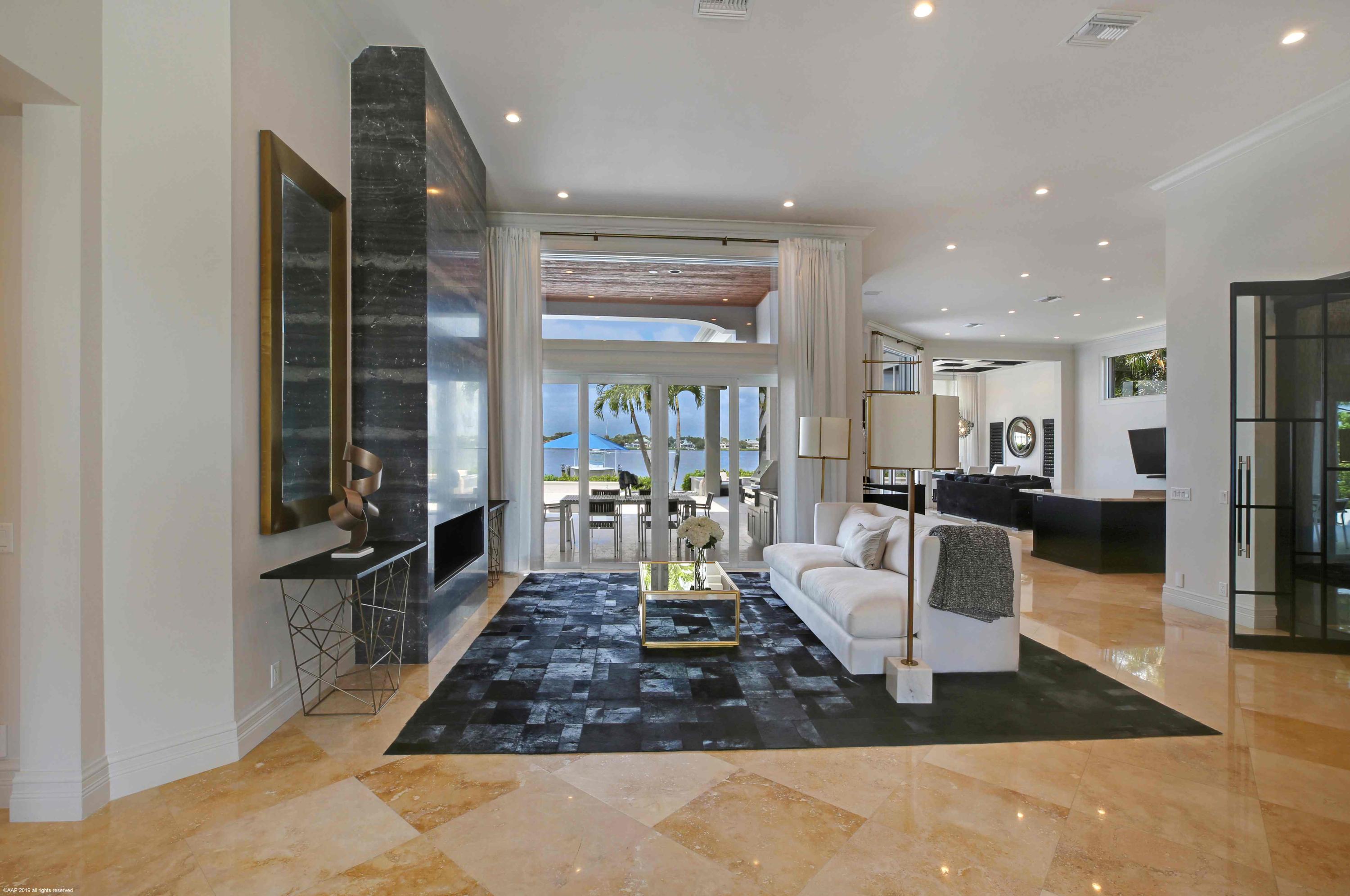 263 River Drive Tequesta, FL 33469 - Photo 13 of 68 a living room with furniture a large window and wood floor