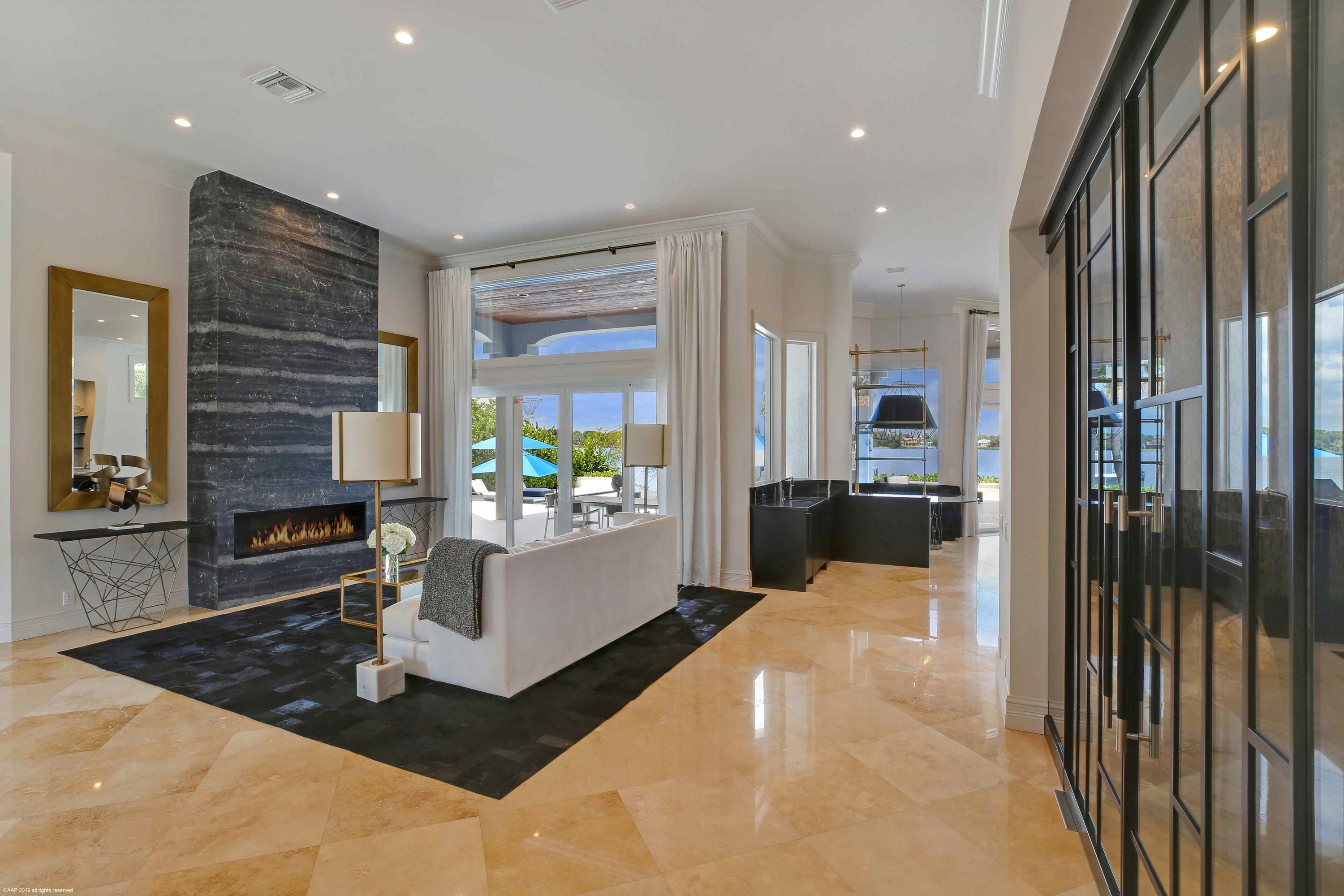 263 River Drive Tequesta, FL 33469 - Photo 14 of 68 a large white kitchen with a large window and stainless steel appliances