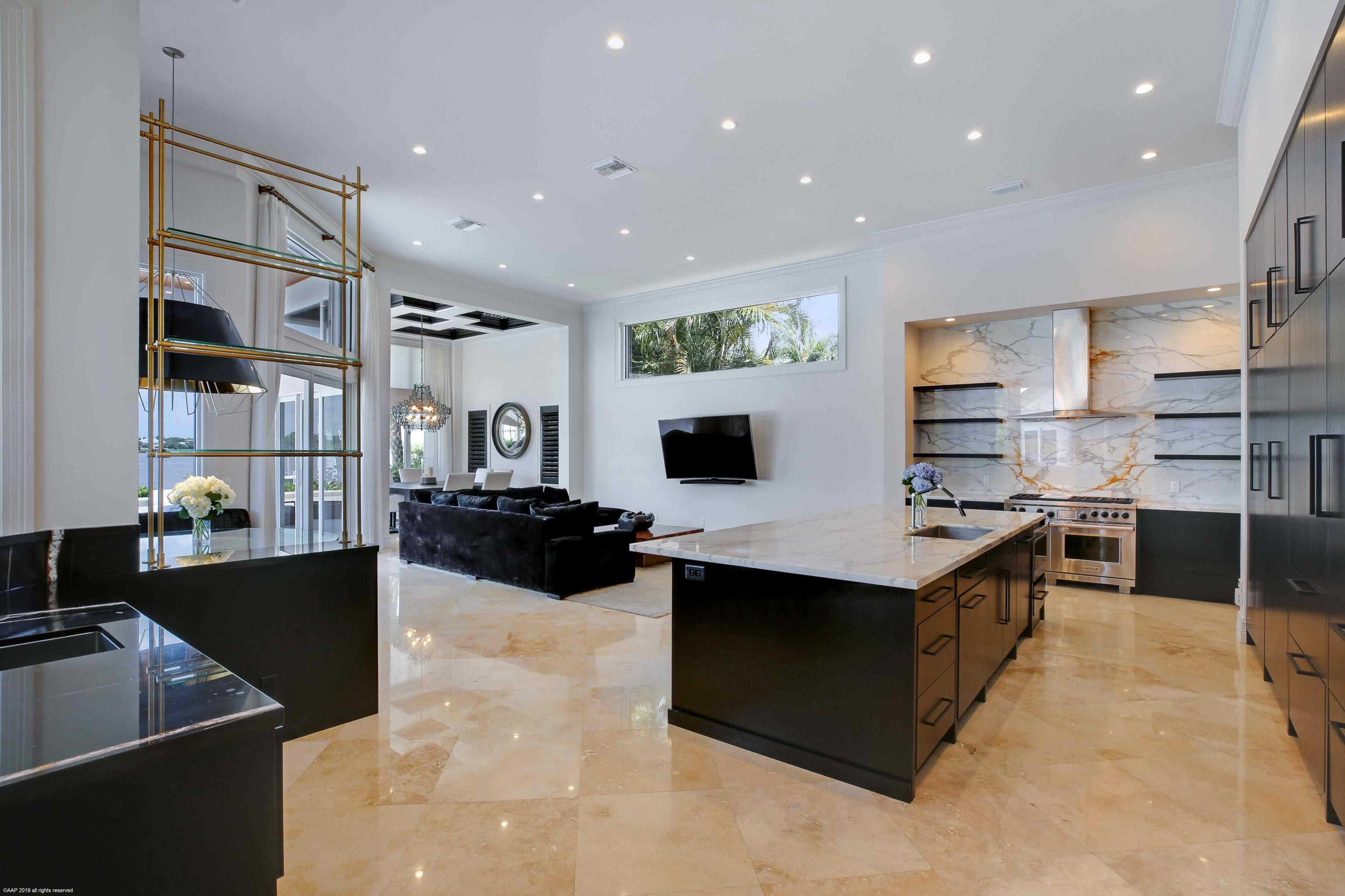 263 River Drive Tequesta, FL 33469 - Photo 22 of 68 a kitchen with stainless steel appliances kitchen island granite countertop a sink and cabinets