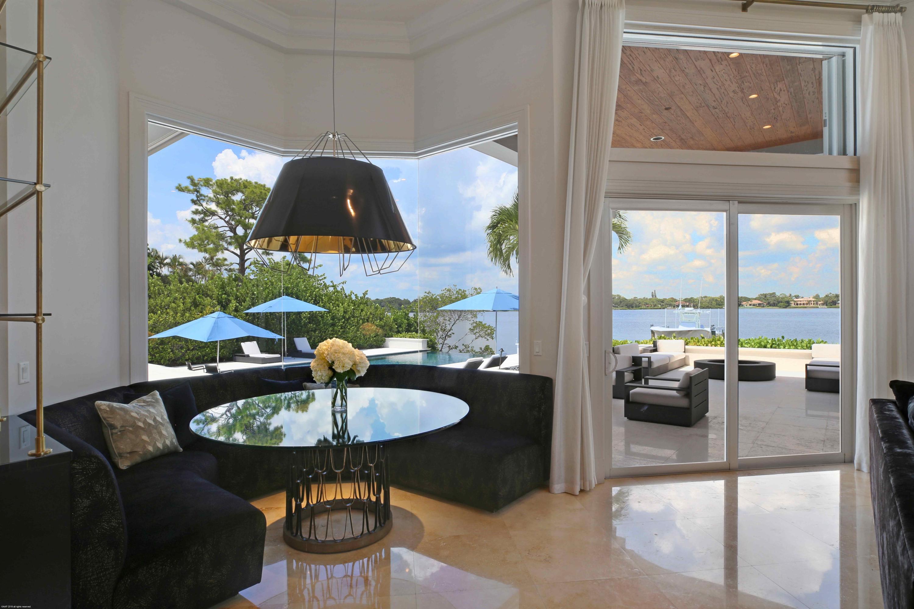 263 River Drive Tequesta, FL 33469 - Photo 29 of 68 a dining room with furniture and chandelier