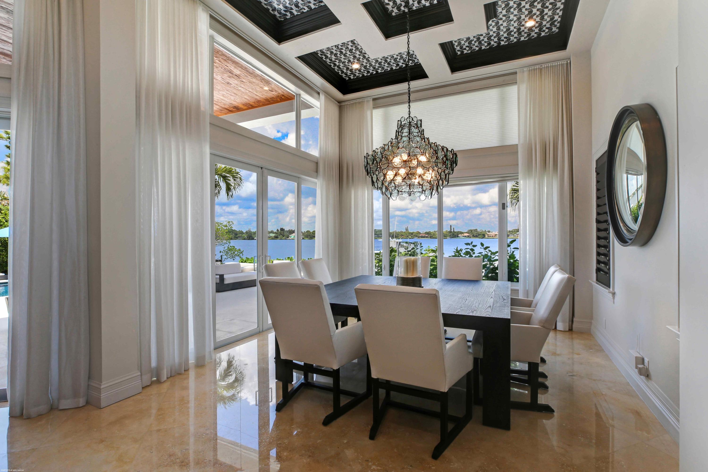 263 River Drive Tequesta, FL 33469 - Photo 32 of 68 a view of a dining room with furniture a chandelier and wooden floor