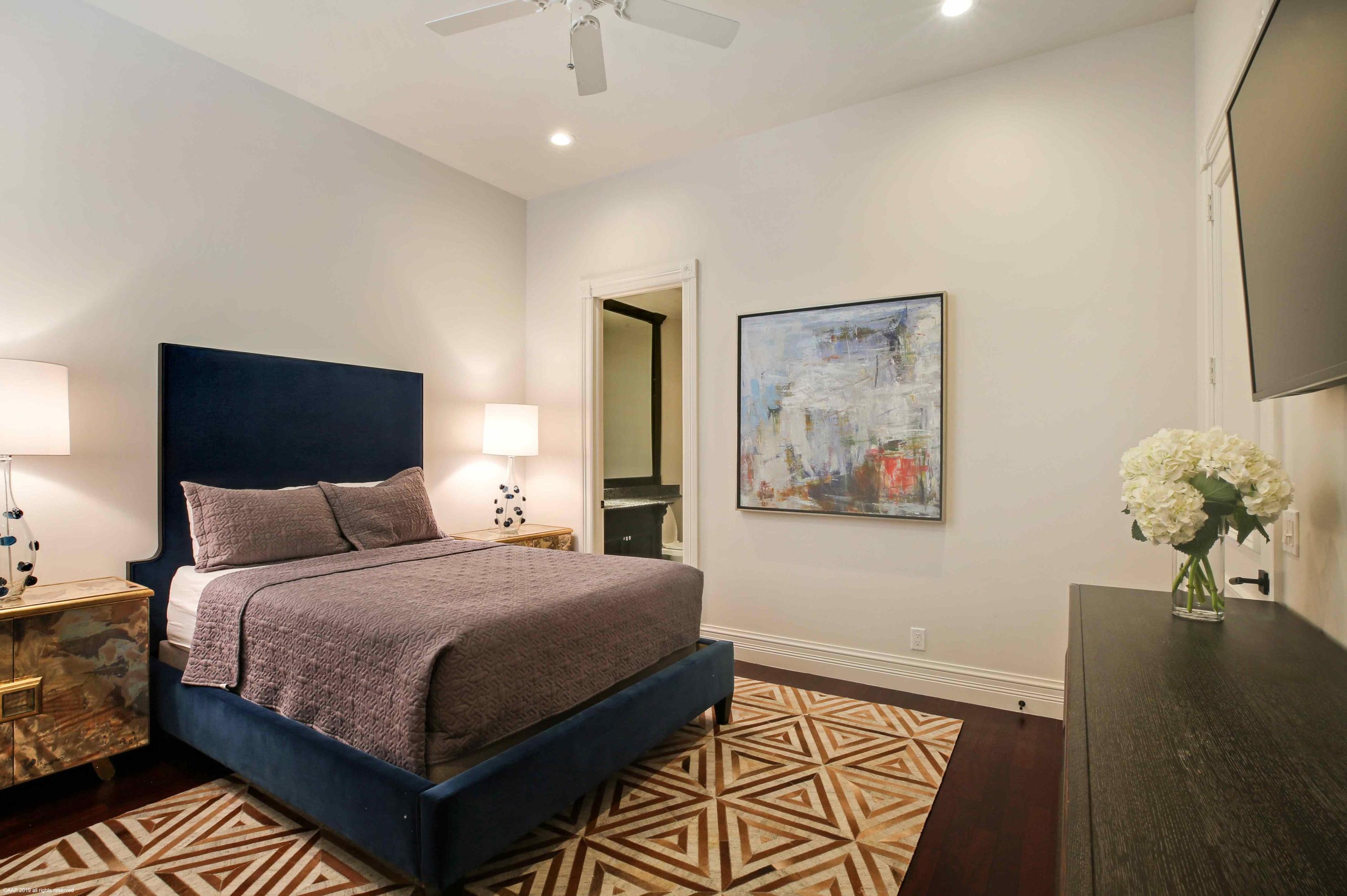 263 River Drive Tequesta, FL 33469 - Photo 42 of 68 a bedroom with a large bed and a chandelier