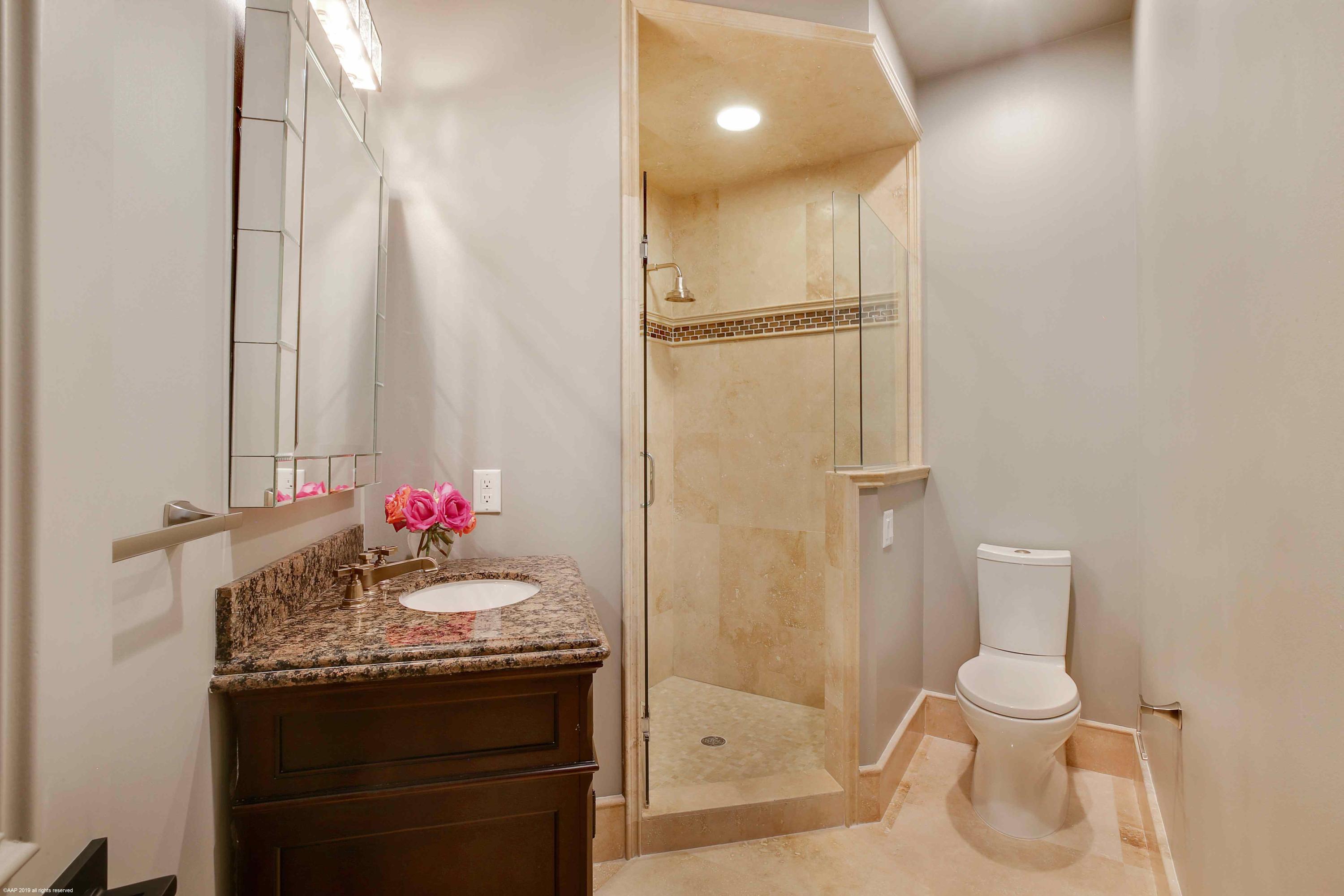 263 River Drive Tequesta, FL 33469 - Photo 49 of 68 a bathroom with a sink vanity mirror and toilet