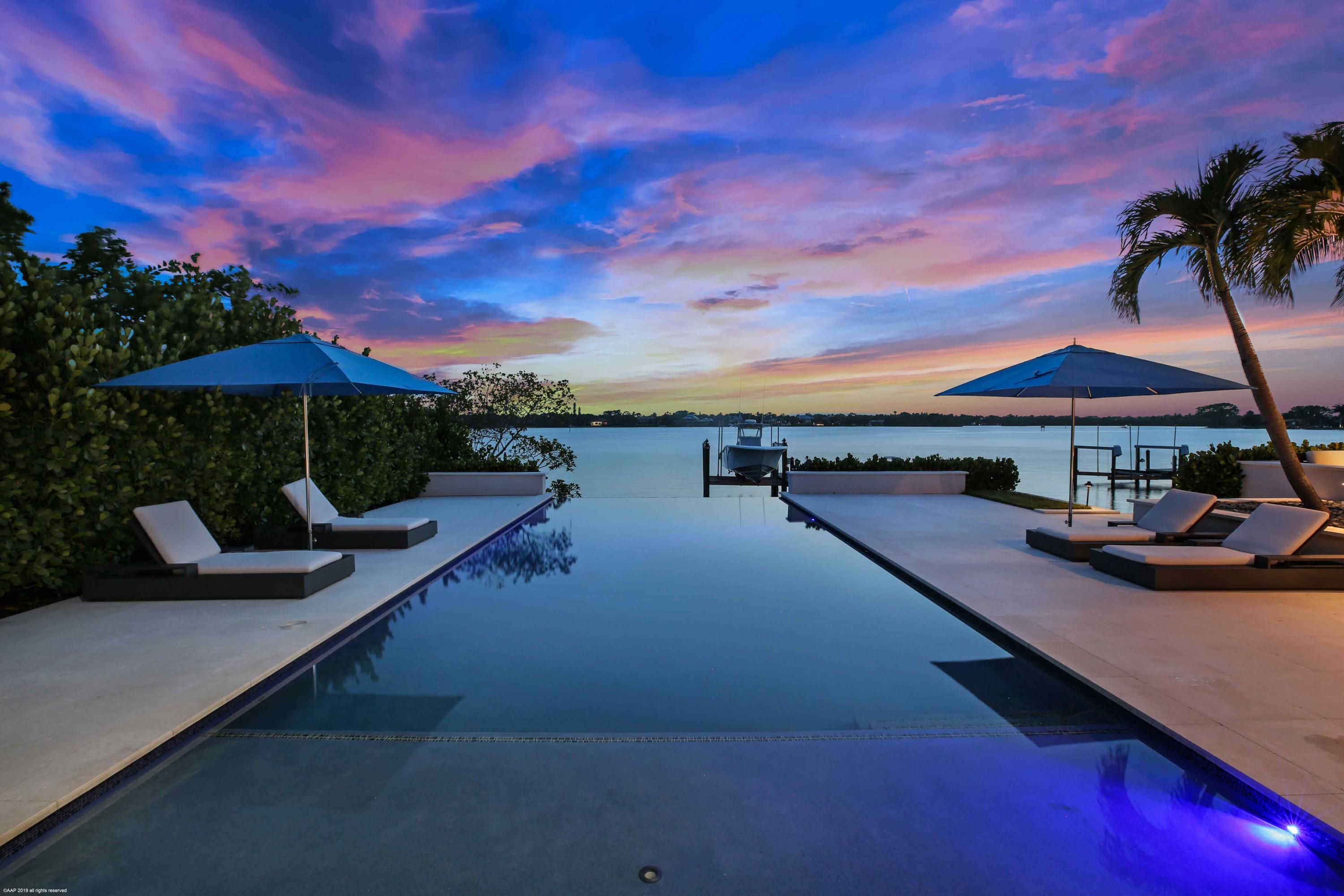 263 River Drive Tequesta, FL 33469 - Photo 57 of 68 a view of swimming pool with outdoor seating