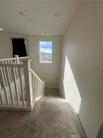 a view of a livingroom with an empty space and a window