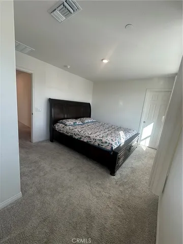 a bedroom with a bed and a cabinets