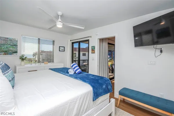 a bedroom with a bed and a flat screen tv