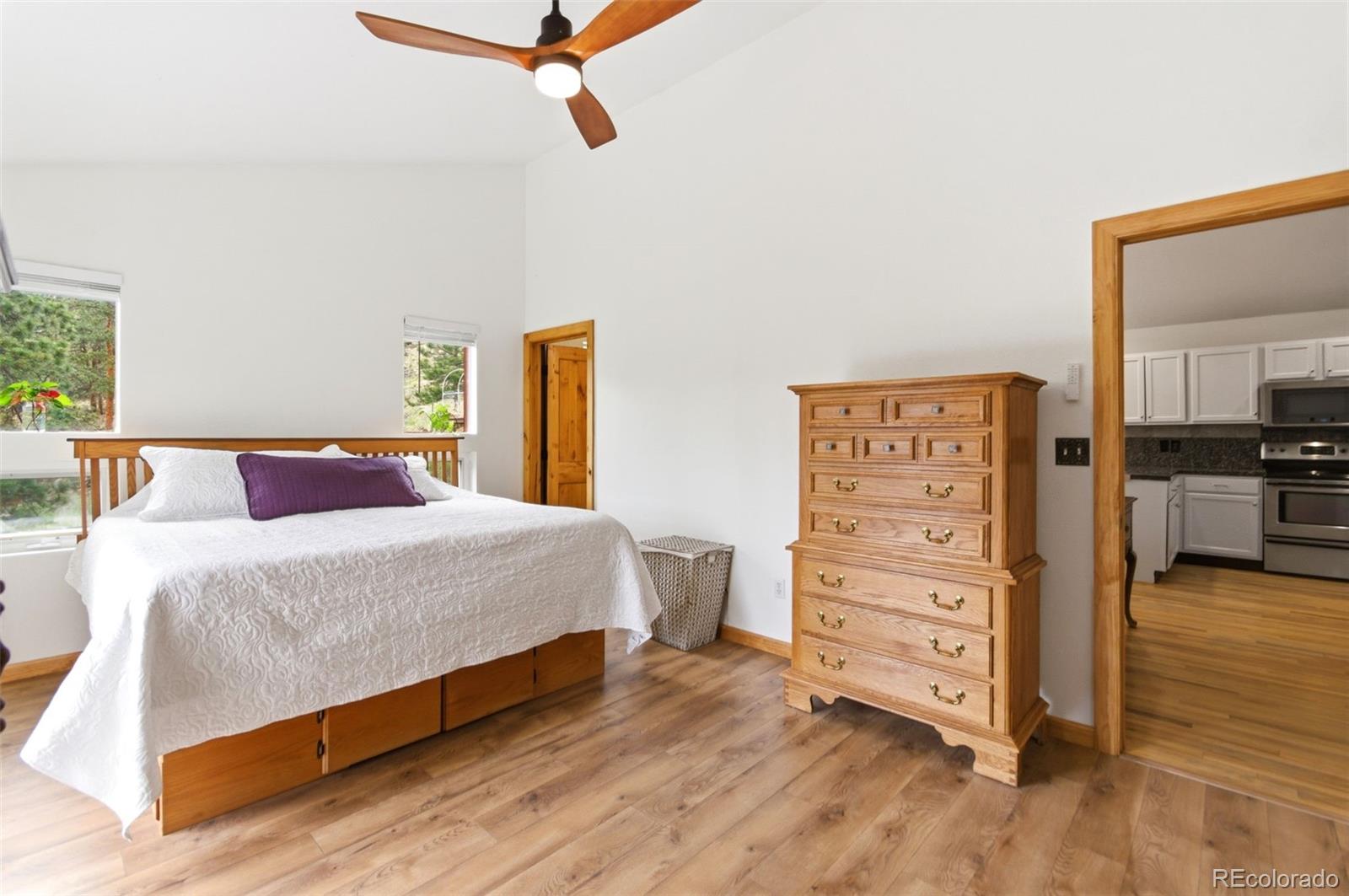 202 Badger Lane Bailey, CO 80421 - Photo 21 of 50 a bedroom with a bed and furniture