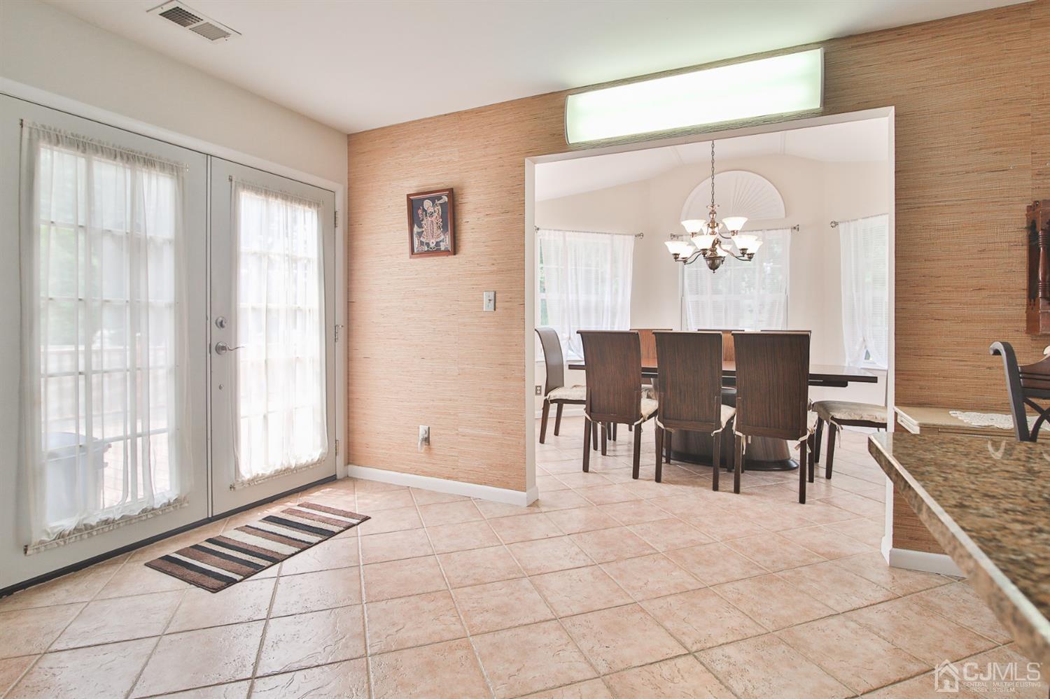 5 Avery Drive Old Bridge, NJ 08857 - Photo 15 of 32 a view of dining room and livingroom with furniture wooden floor a rug and a chandelier