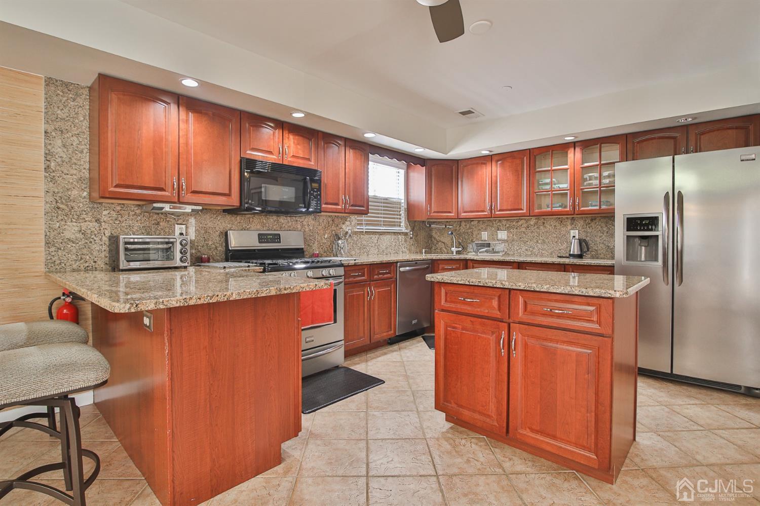 5 Avery Drive Old Bridge, NJ 08857 - Photo 17 of 32 a kitchen with stainless steel appliances granite countertop a stove a sink dishwasher a refrigerator and a microwave oven