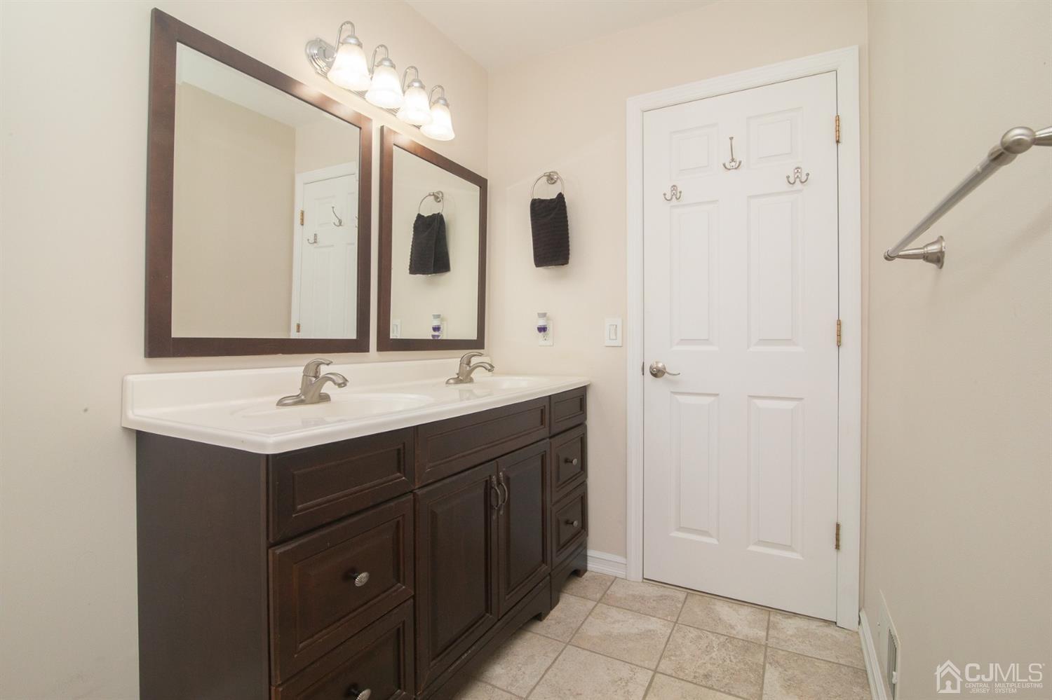 5 Avery Drive Old Bridge, NJ 08857 - Photo 20 of 32 a bathroom with a double vanity sink a mirror and a bathtub