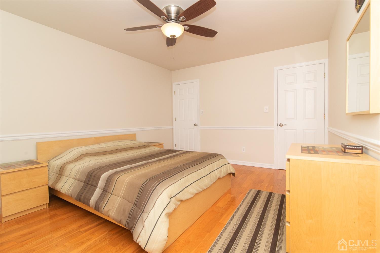 5 Avery Drive Old Bridge, NJ 08857 - Photo 26 of 32 a bedroom with a bed and a chandelier
