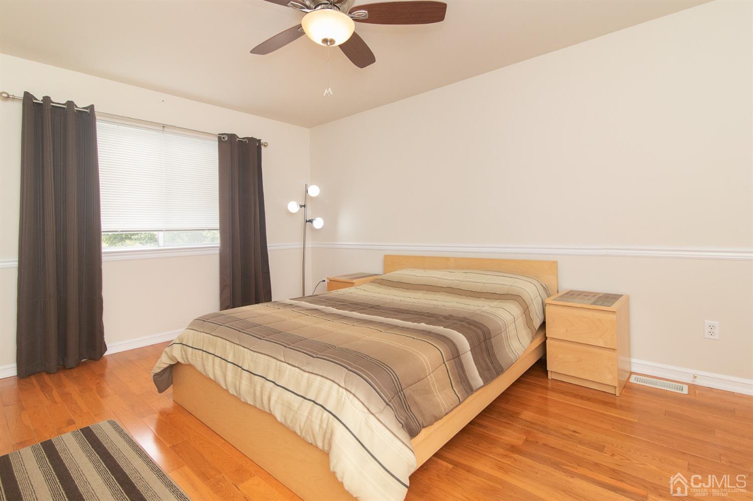 5 Avery Drive Old Bridge, NJ 08857 - Photo 27 of 32 a bedroom with a bed and a chandelier