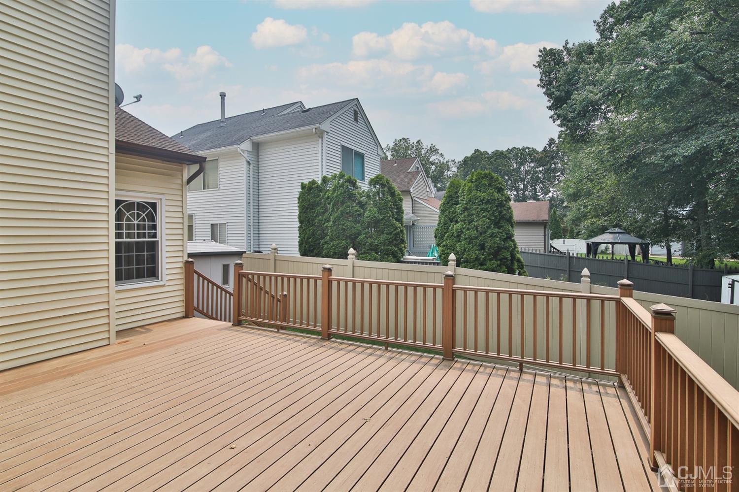 5 Avery Drive Old Bridge, NJ 08857 - Photo 4 of 32 a view of a deck with wooden floor and fence
