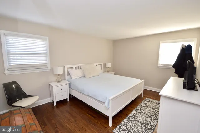 a bedroom with a bed and a chair