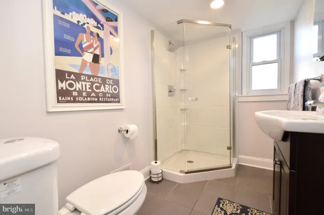 a bathroom with a toilet sink and shower