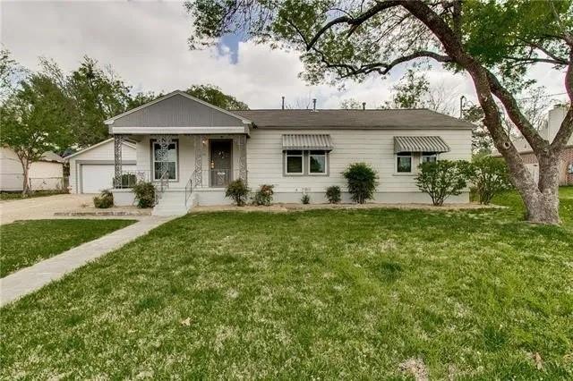 a front view of a house with yard and green space