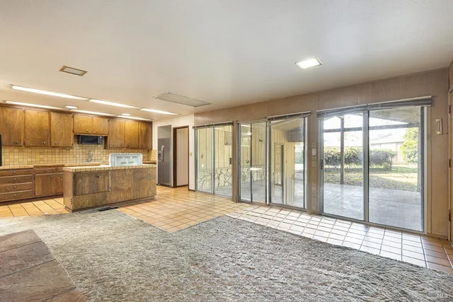 a view of a livingroom with a ceiling fan and window