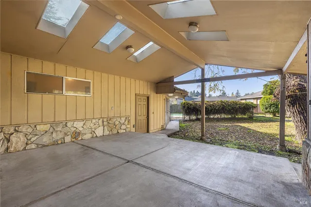 a view of a livingroom with wooden floor and a ceiling fan