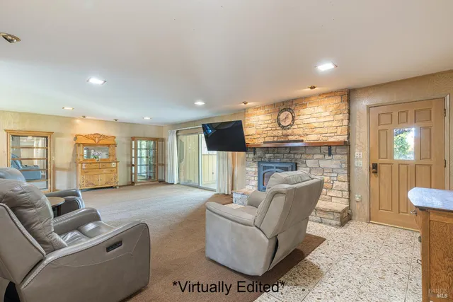a living room with furniture and large windows