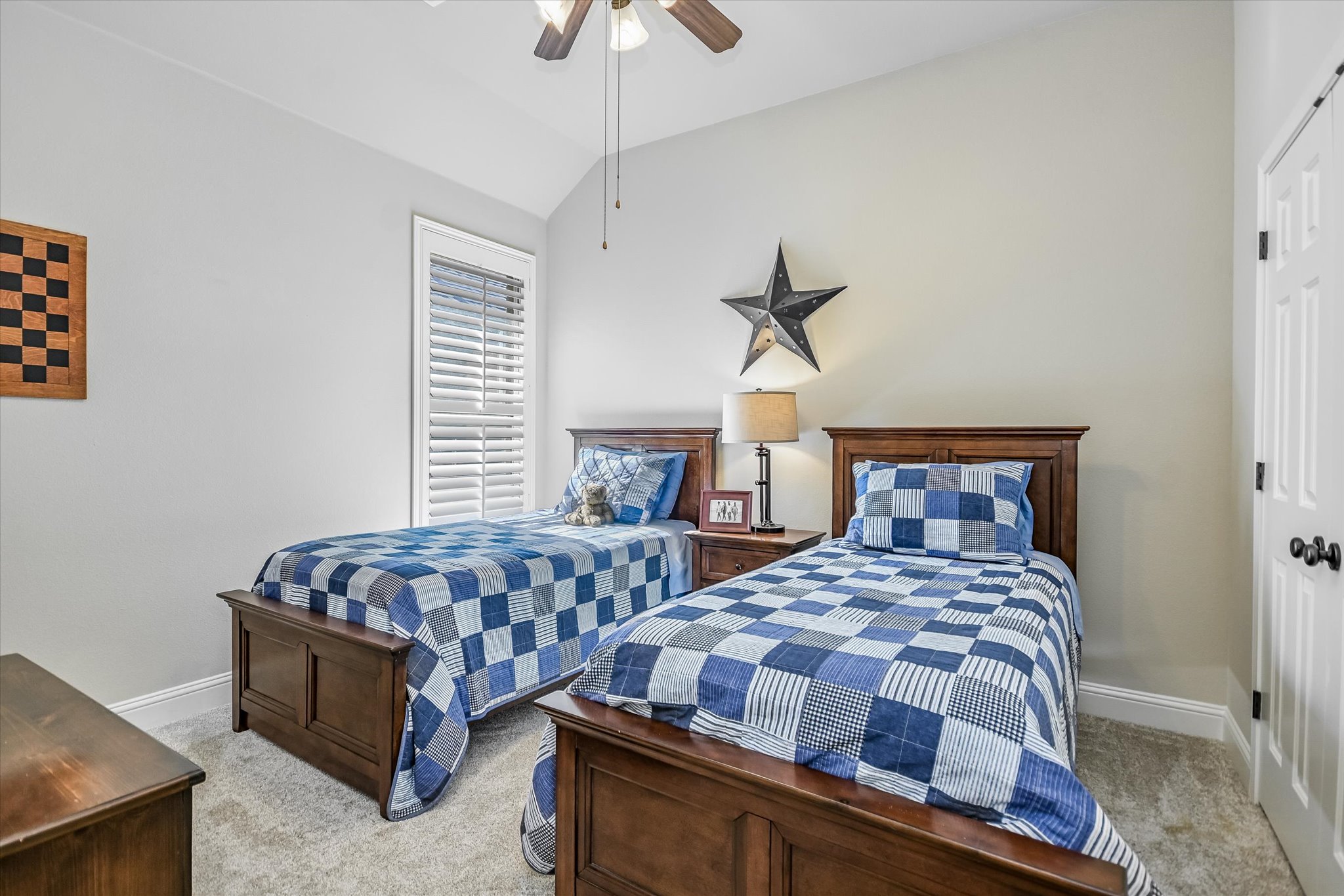409 Harris Drive Austin, TX 78737 - Photo 12 of 29 a bedroom with two beds and a chandelier