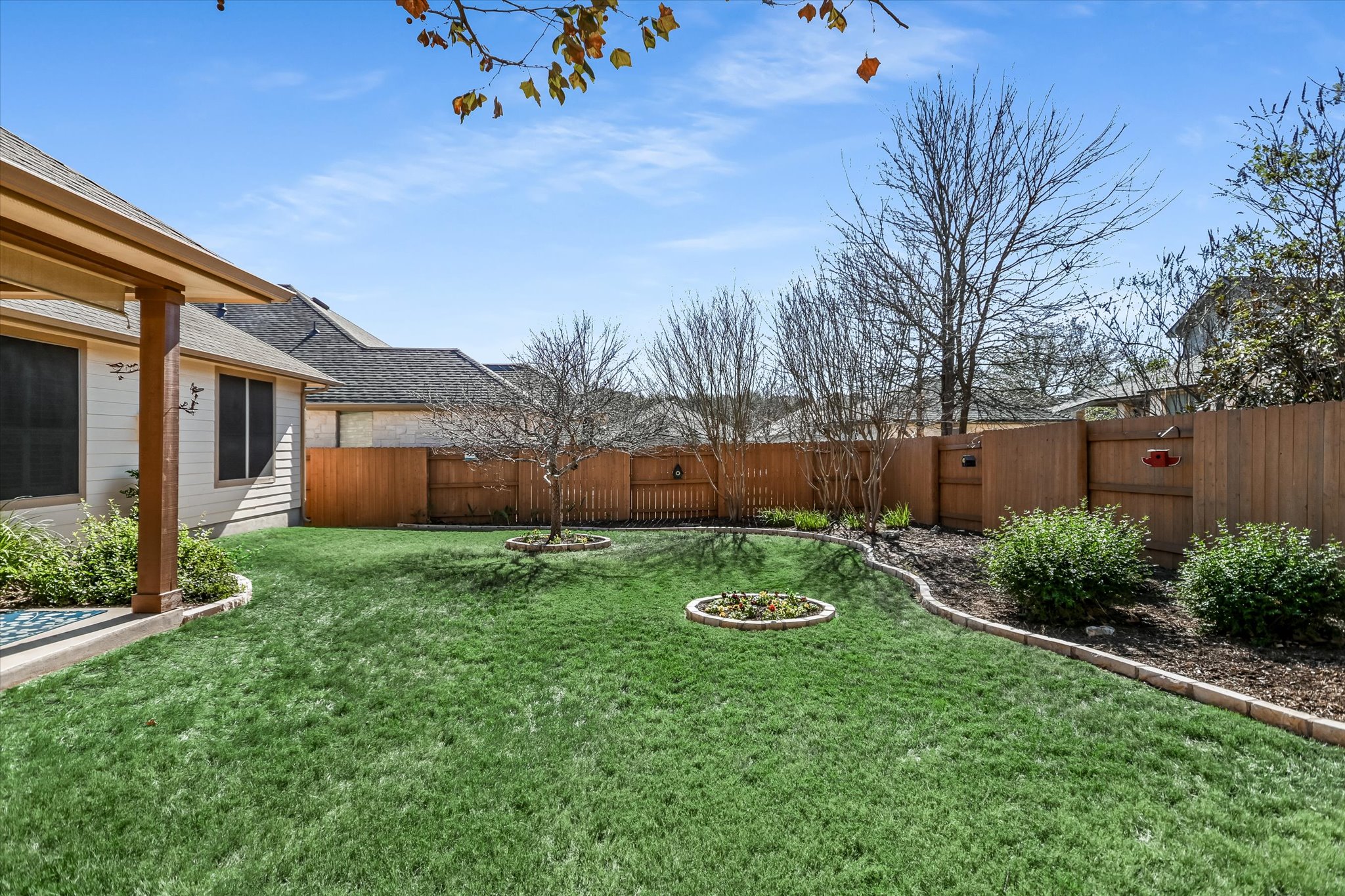 409 Harris Drive Austin, TX 78737 - Photo 17 of 29 a view of a house with backyard and sitting area