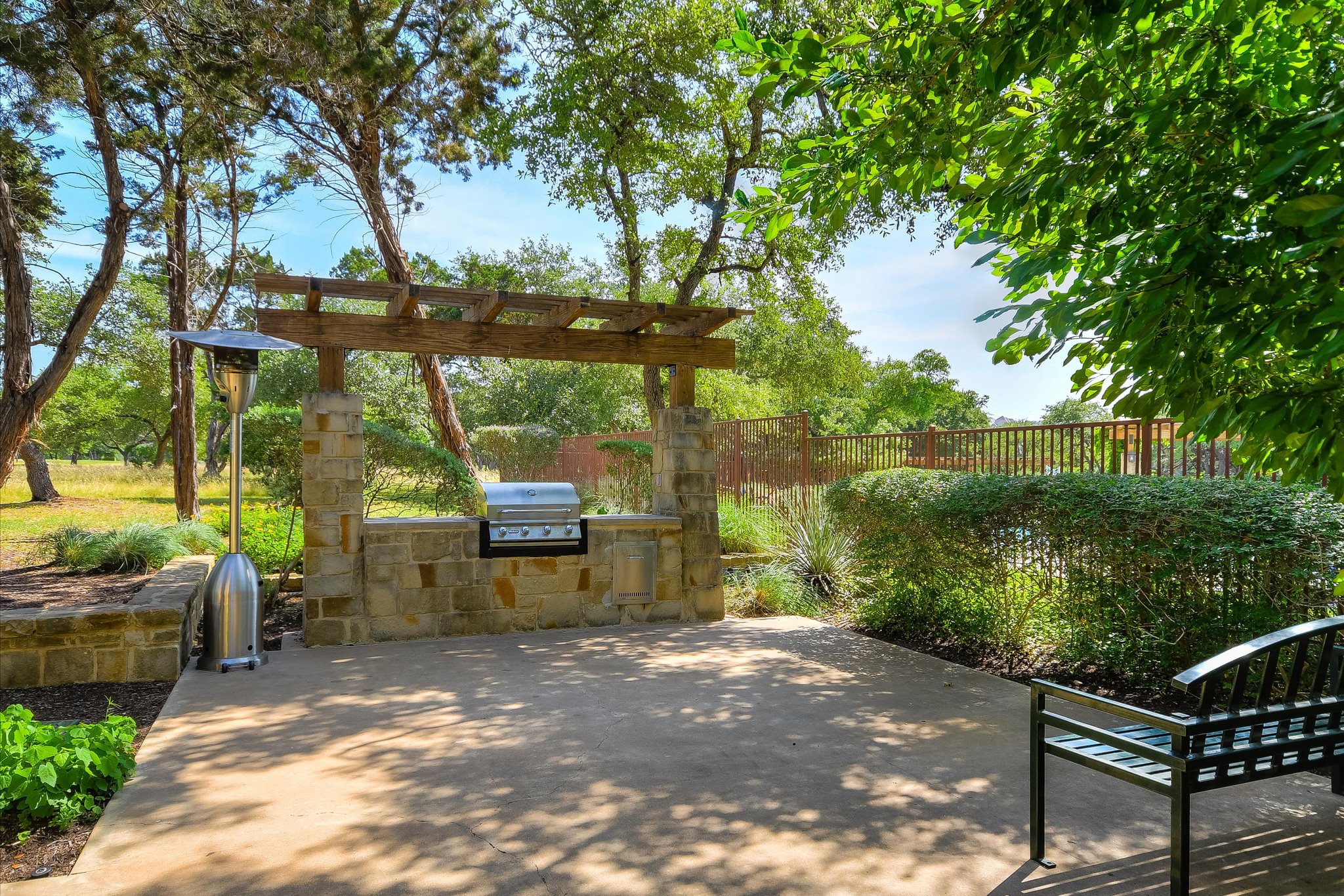 409 Harris Drive Austin, TX 78737 - Photo 23 of 29 a view of a patio with table and chairs potted plants with large tree