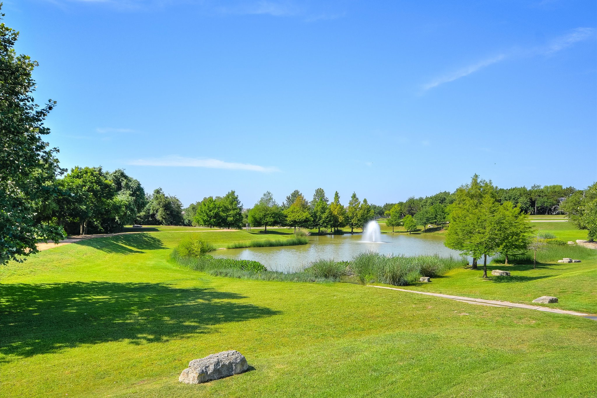 409 Harris Drive Austin, TX 78737 - Photo 26 of 29 a view of a city with lawn chairs and a large tree