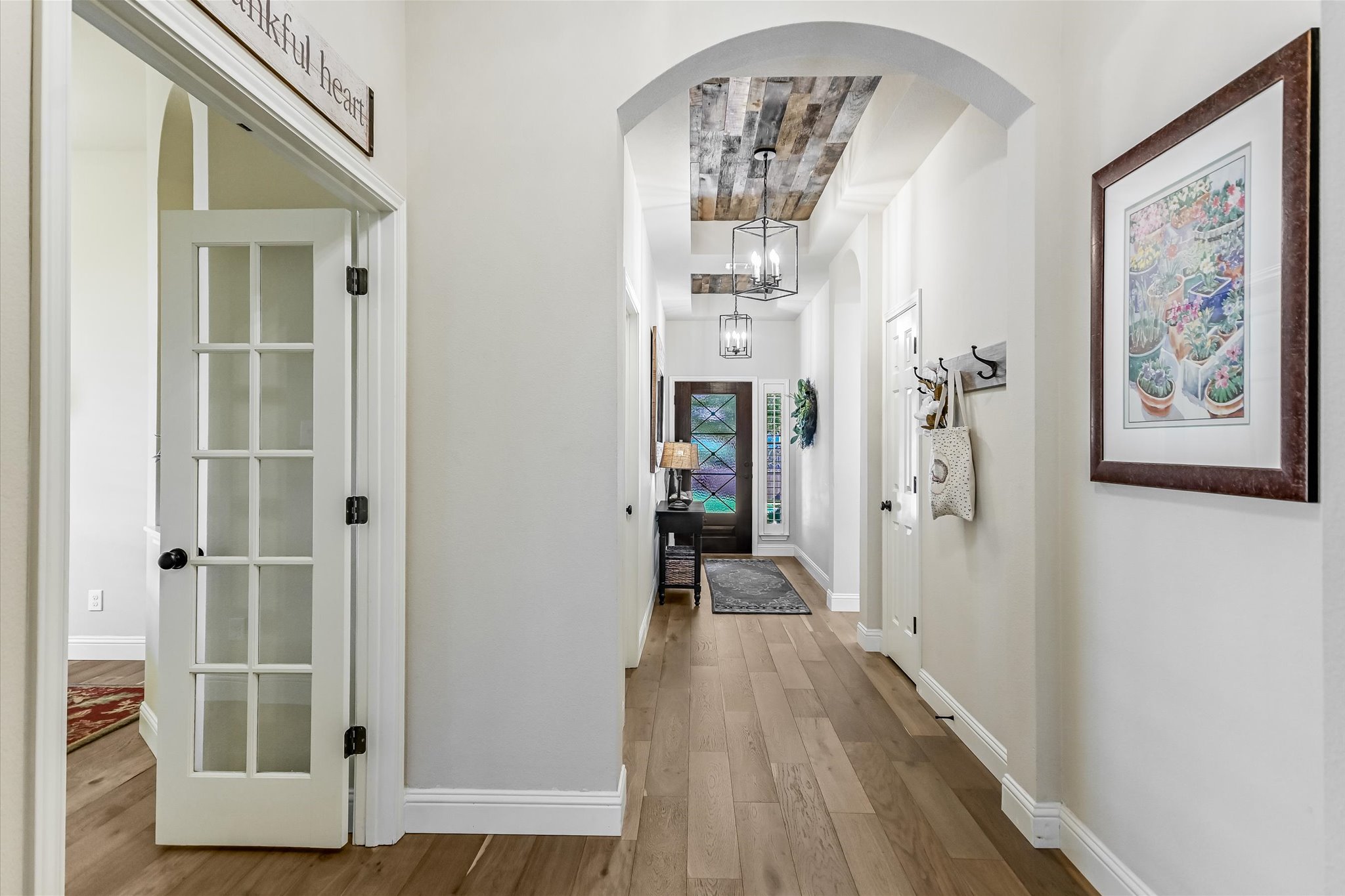 409 Harris Drive Austin, TX 78737 - Photo 4 of 29 a view of a hallway with wooden floor and staircase