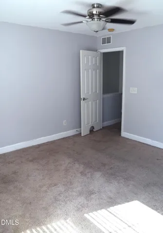 a view of a hallway to a livingroom and a livingroom with furniture