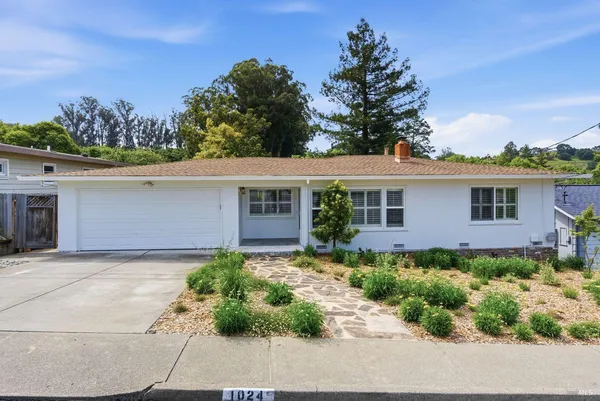 a front view of a house with garden