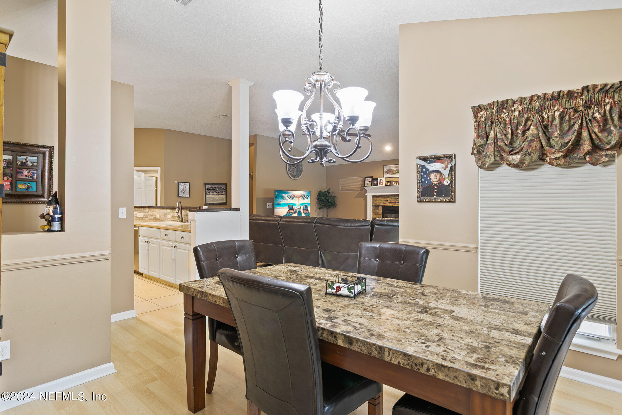 809 Mill Pond Court St. Johns, FL 32259 - Photo 12 of 50 a view of a dining room with furniture a chandelier and wooden floor