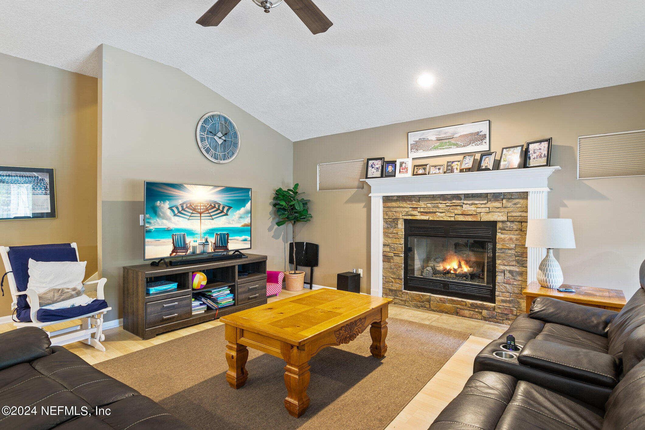 809 Mill Pond Court St. Johns, FL 32259 - Photo 14 of 50 a living room with furniture a flat screen tv and a fireplace