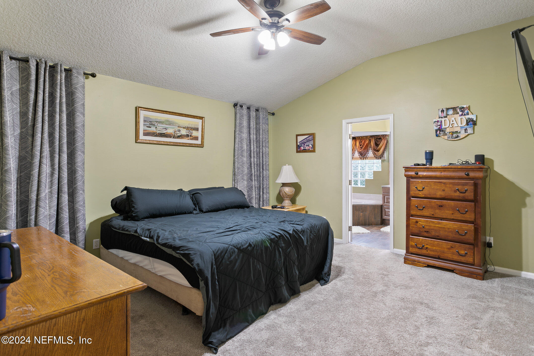 809 Mill Pond Court St. Johns, FL 32259 - Photo 17 of 50 a spacious bedroom with a bed and a cabinet