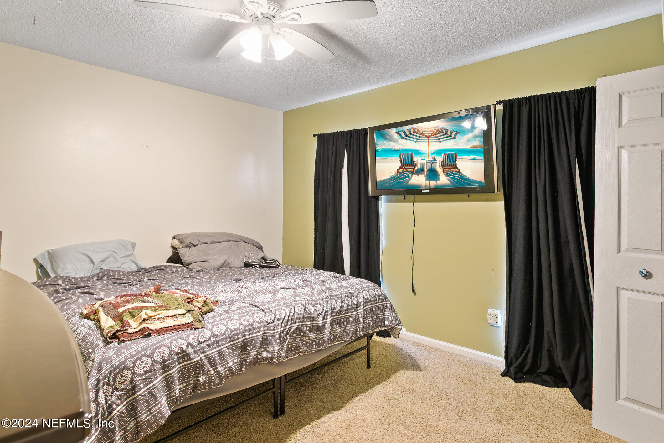 809 Mill Pond Court St. Johns, FL 32259 - Photo 21 of 50 a bedroom with a bed and a chandelier