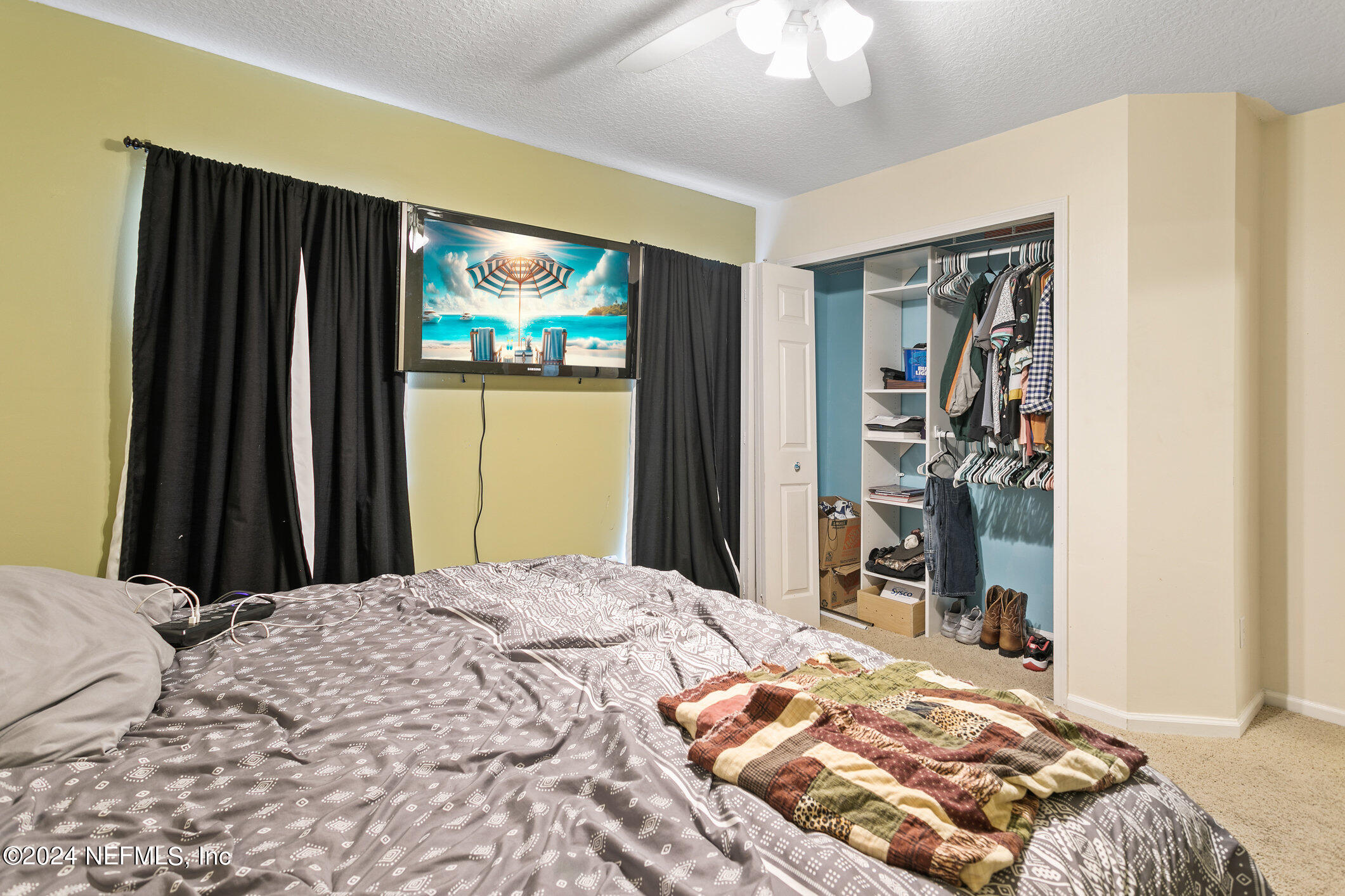 809 Mill Pond Court St. Johns, FL 32259 - Photo 22 of 50 a bedroom with a bed and a large mirror with a flat tv screen
