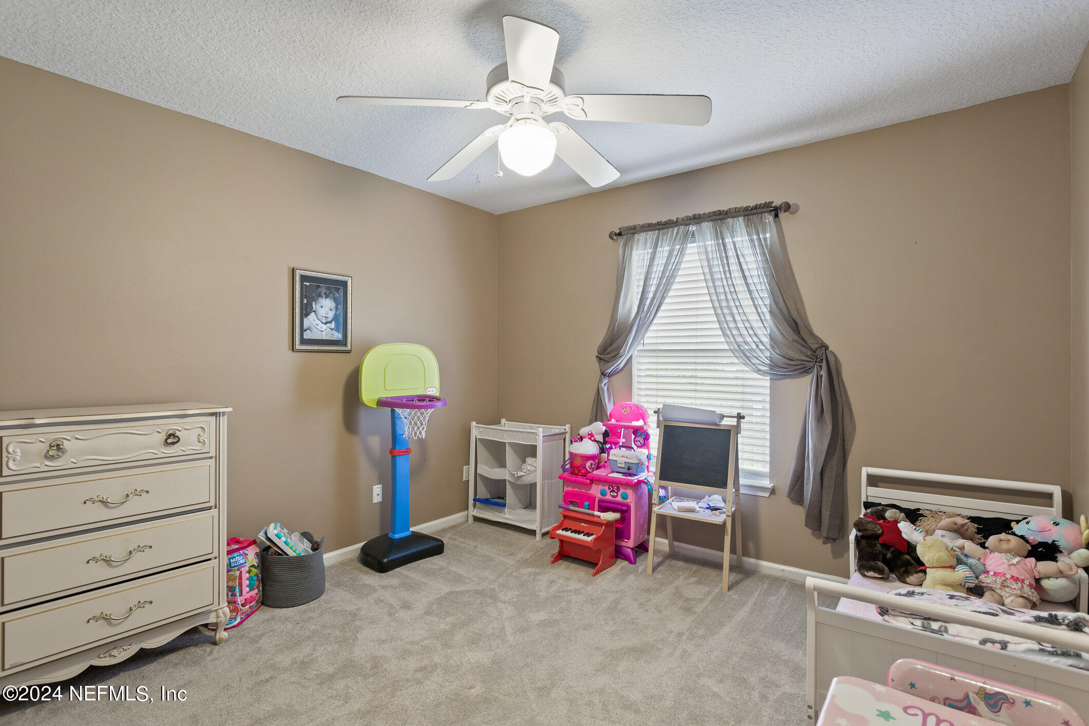 809 Mill Pond Court St. Johns, FL 32259 - Photo 24 of 50 a bedroom with a bed a window and book shelf
