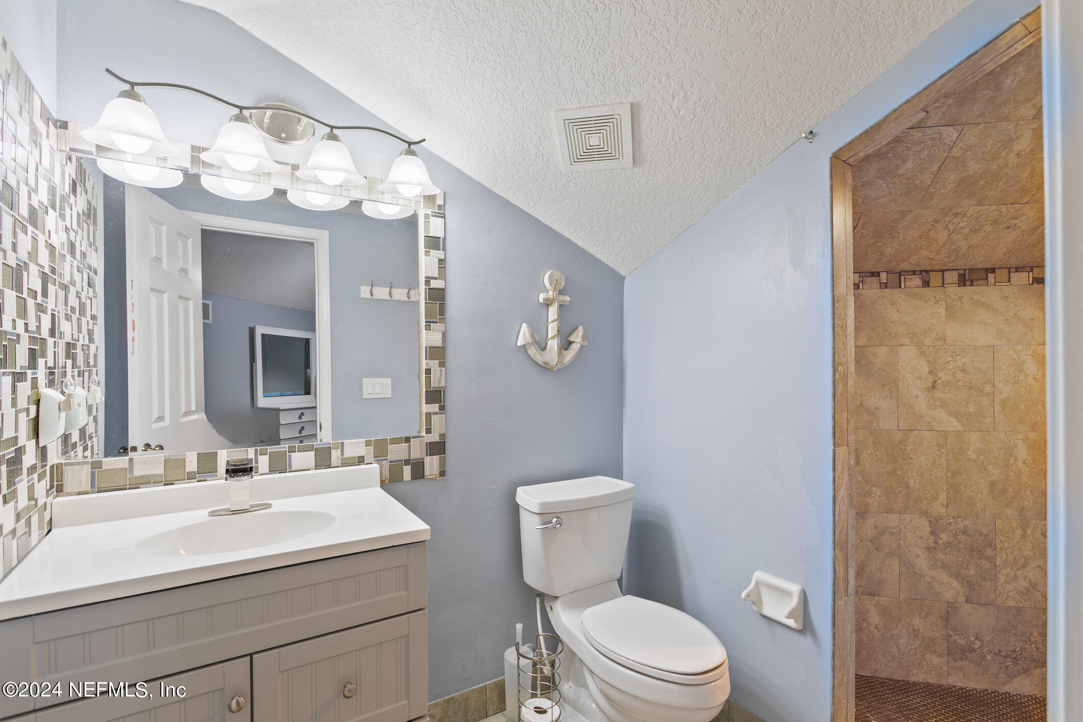 809 Mill Pond Court St. Johns, FL 32259 - Photo 30 of 50 a bathroom with a sink a mirror a toilet and a shower