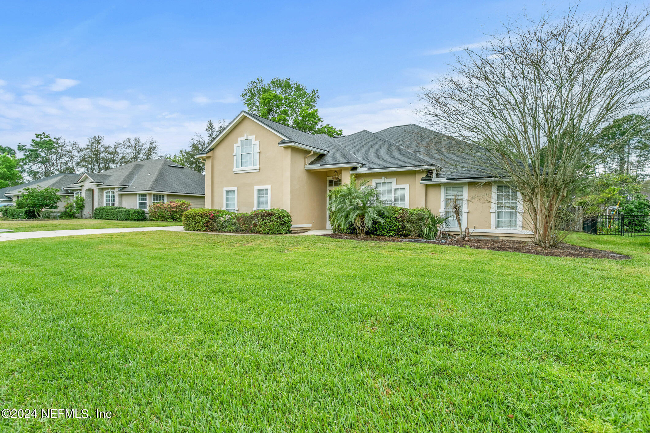 809 Mill Pond Court St. Johns, FL 32259 - Photo 3 of 50 a front view of a house with a yard and trees