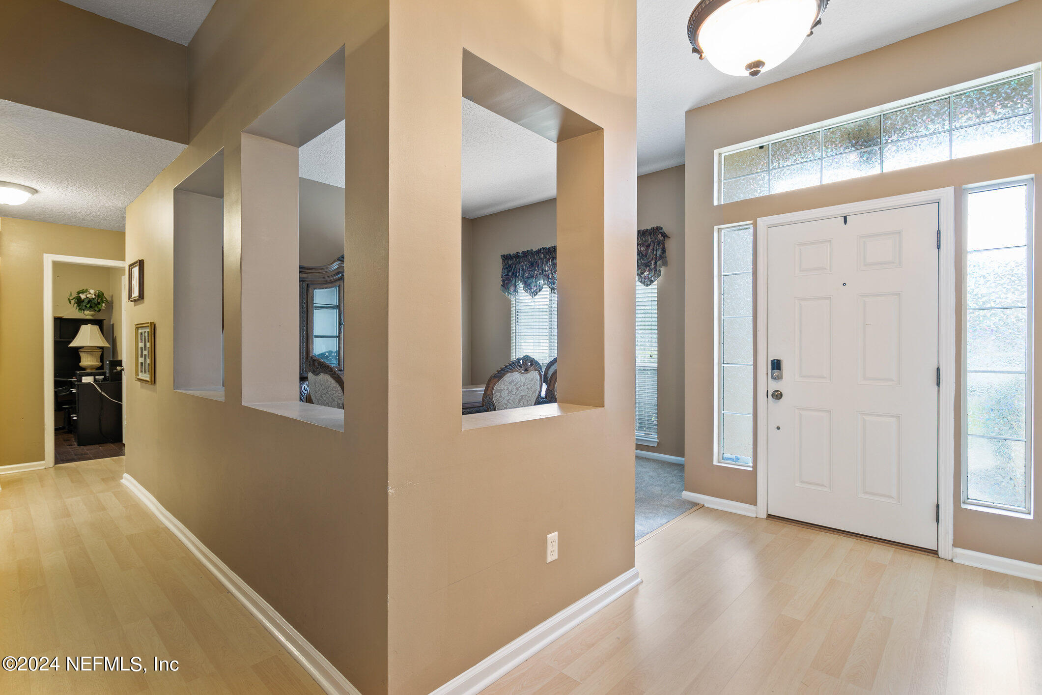 809 Mill Pond Court St. Johns, FL 32259 - Photo 4 of 50 a view of a hallway with wooden floor and a living room