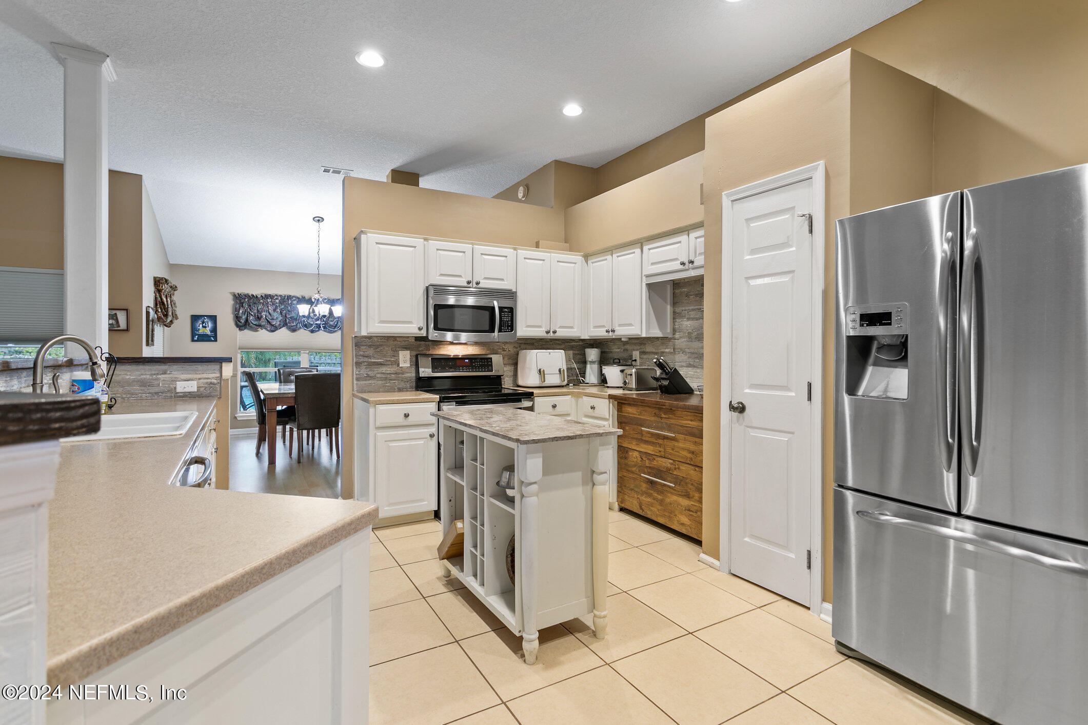 809 Mill Pond Court St. Johns, FL 32259 - Photo 8 of 50 a kitchen with stainless steel appliances a refrigerator sink and microwave