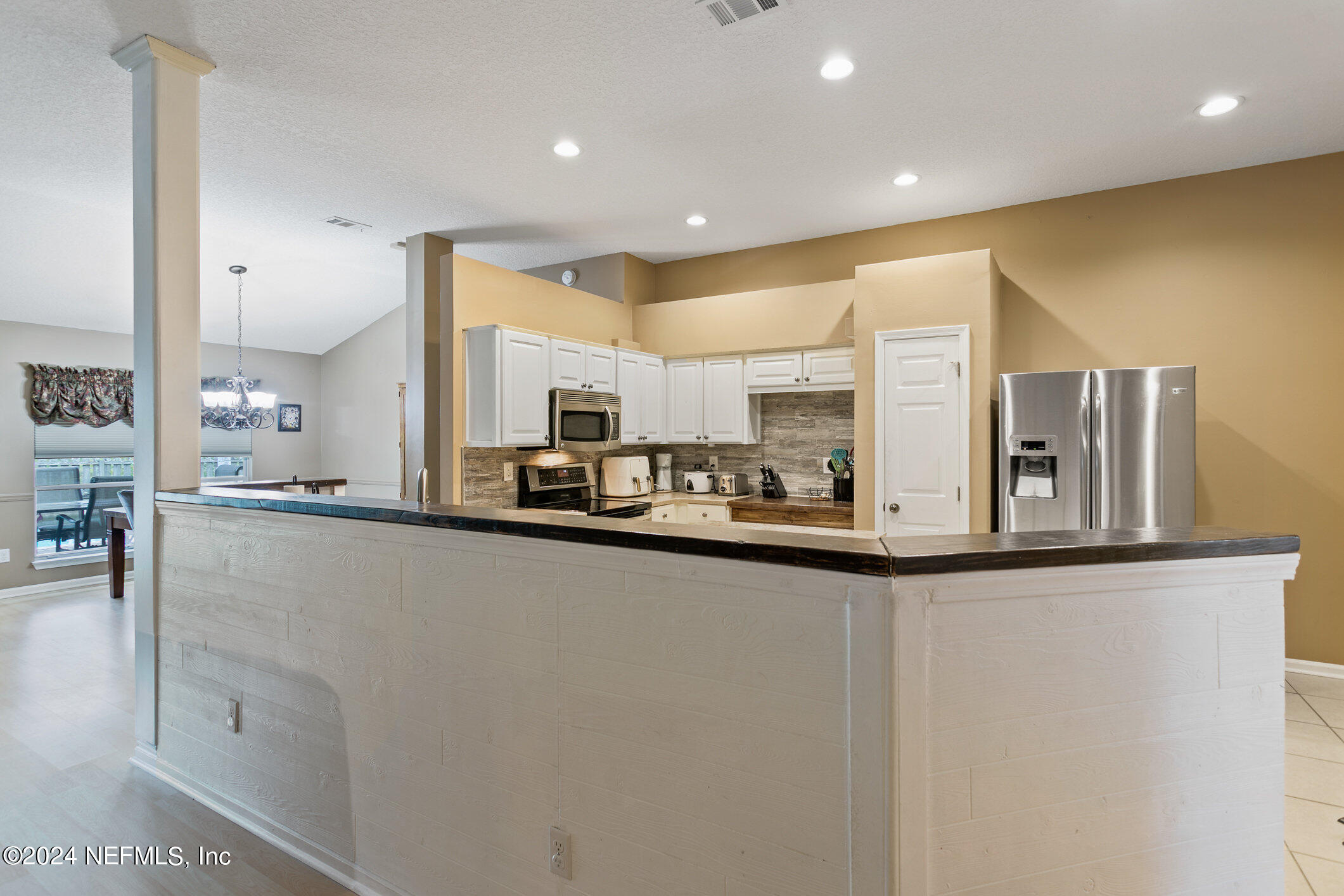 809 Mill Pond Court St. Johns, FL 32259 - Photo 10 of 50 a kitchen with stainless steel appliances granite countertop a sink and cabinets